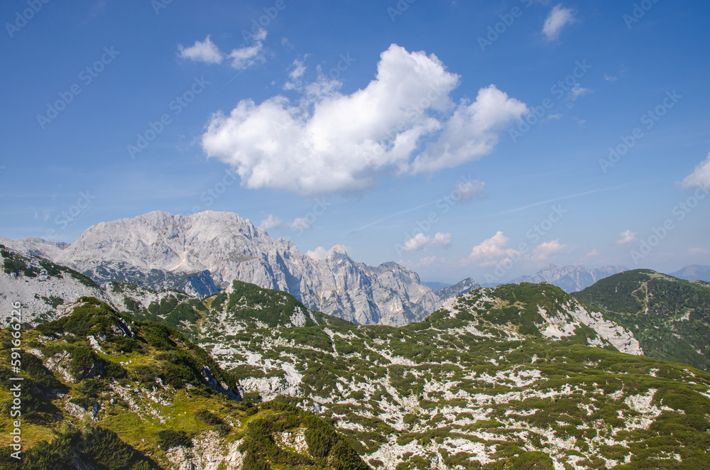 Obraz premium A view of the Julian Alps in Triglav national park. Mountain peaks are partially covered in permanent snow. Beautiful texture of typical limestone rock.