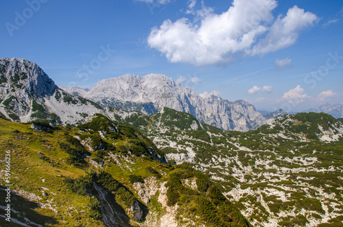 A view of the Julian Alps in Triglav national park. Mountain peaks are partially covered in permanent snow. Beautiful texture of typical limestone rock.