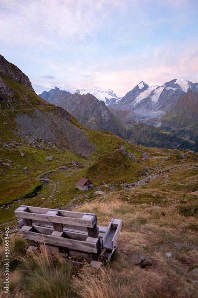 Bench in the Swiss Alps overseeing sunrise