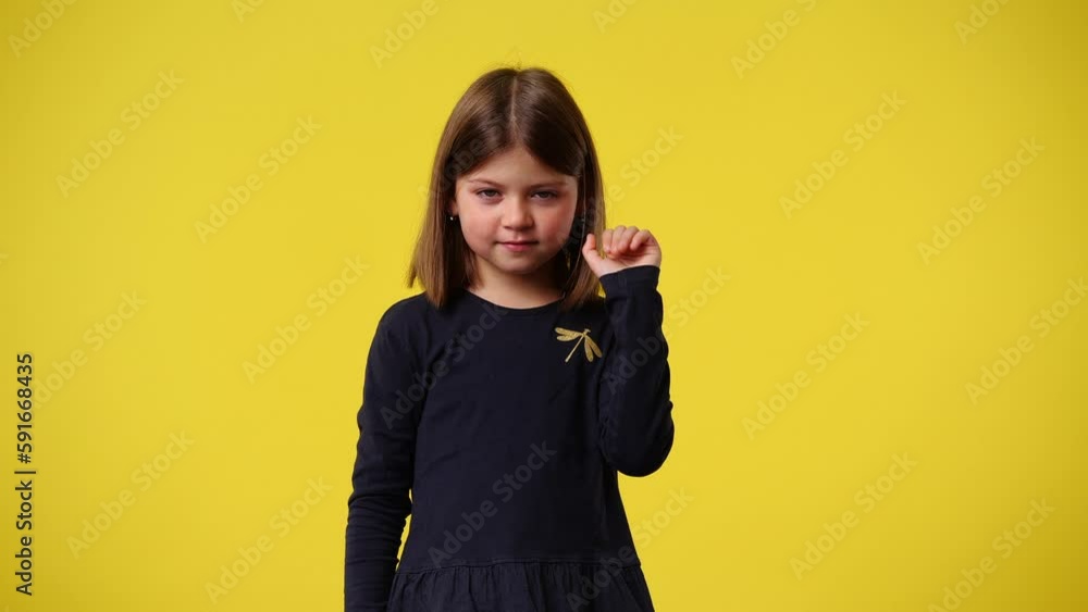 4k video of cute girl smiling over yellow background. 4k video of cute girl smiling over yellow background.
