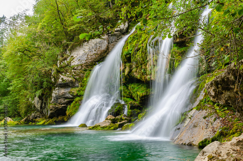 Side view of fairytale Virje waterfall in Slovenia - Pluzna. Dreamy and beautiful natural double waterfall shot on long exposure. © Jan