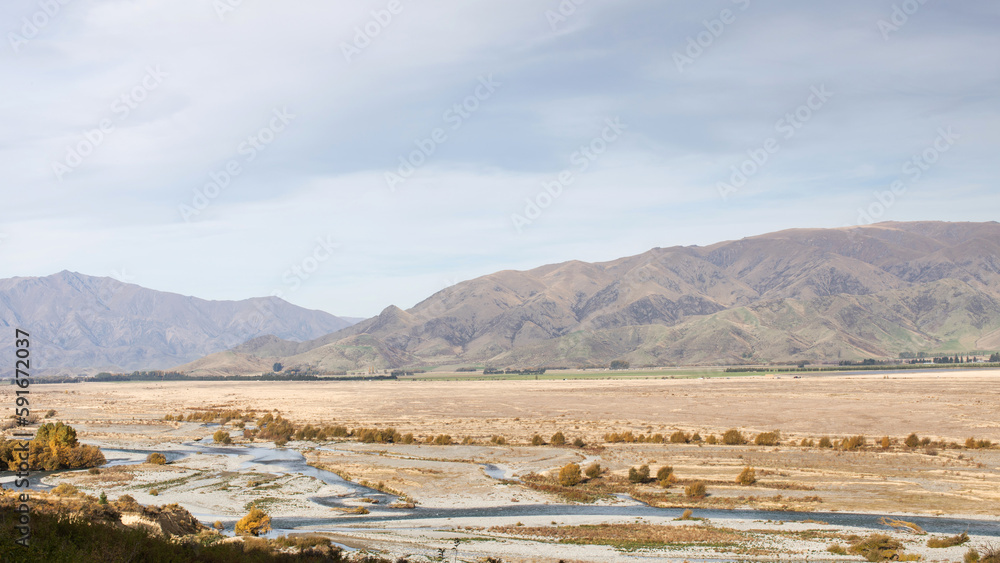 Landscape of a valley with a river surrounded by mountains. New Zealand.