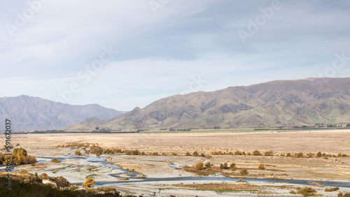Landscape of a valley with a river surrounded by mountains. New Zealand.