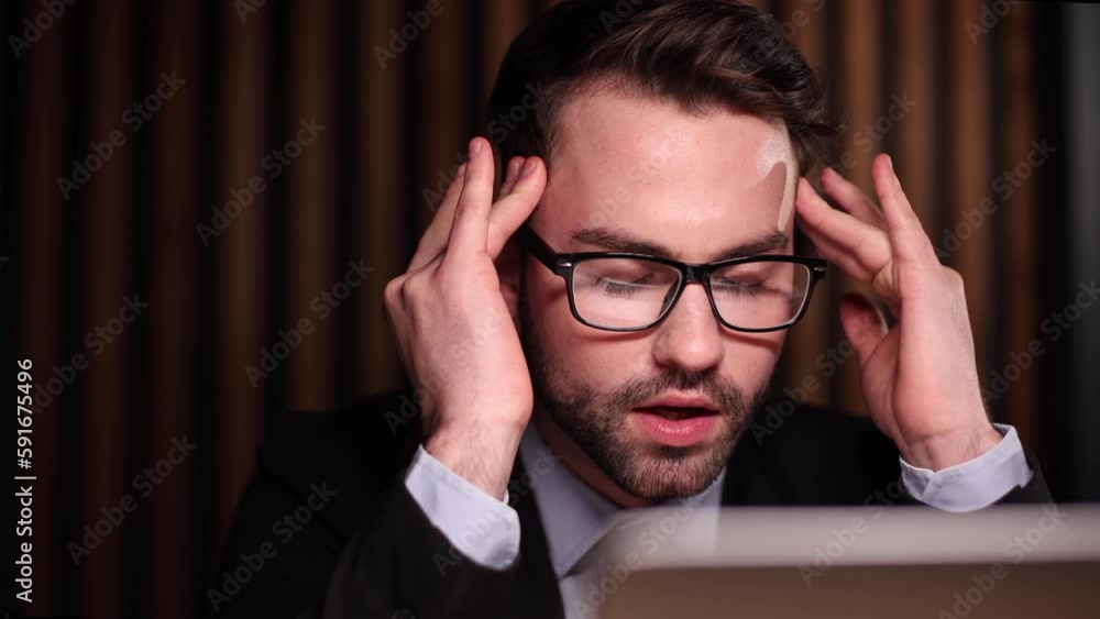 Tired exhausted man, office worker, manager or freelancer, sitting at his desk, tired of working in a laptop Tired exhausted man, office worker, manager or freelancer, sitting at his desk, tired of working in a laptop