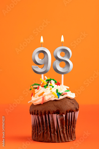 Candle number 98 - Cake birthday in orange background