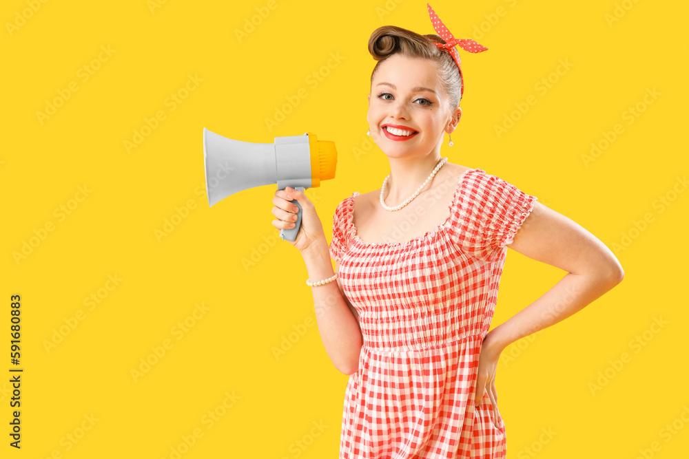 Young pin-up woman with megaphone on yellow background Young pin-up woman with megaphone on yellow background