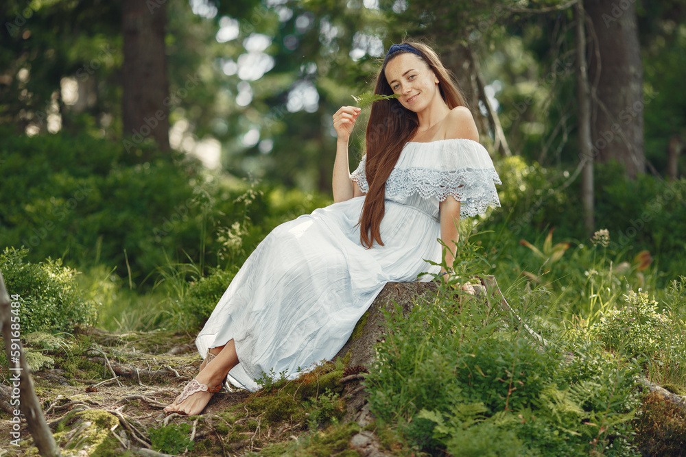 Stylish woman spending time in a summer forest Stylish woman spending time in a summer forest
