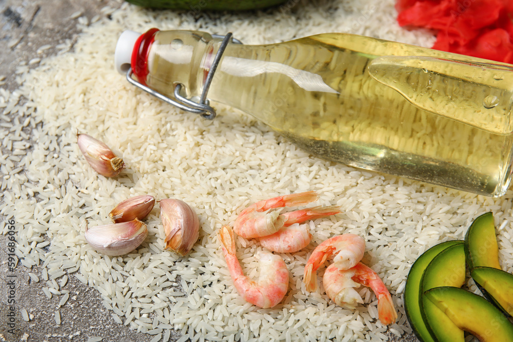Composition with bottle of rice vinegar and different ingredients for preparing sushi rolls on grunge background, closeup