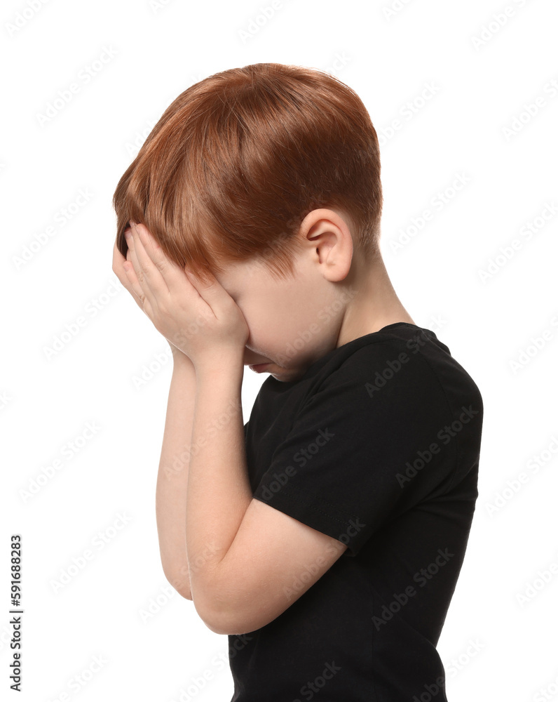 Boy covering face with hands on white background. Children's bullying Boy covering face with hands on white background. Children's bullying