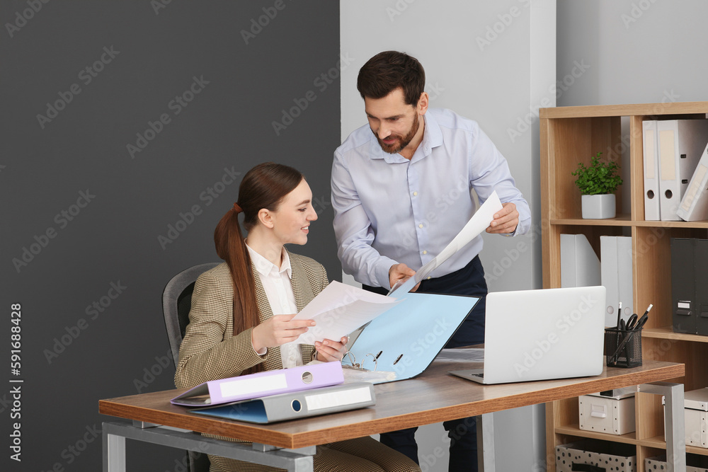Businesspeople working together with documents in office Businesspeople working together with documents in office
