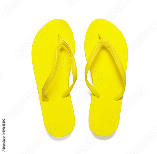 Pair of yellow flip-flops on white background