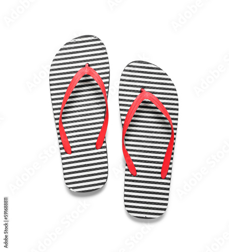 Pair of striped flip-flops on white background