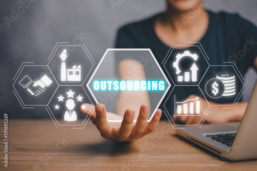 Papier peint Outsourcing Global Recruitment Business and internet concept, Business person hand holding outsourcing icon on virtual screen with blue bokeh background