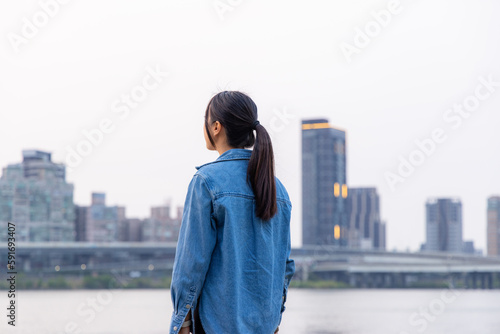 Woman look at the view in riverside of Taipei city