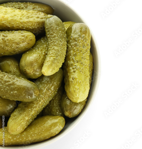 Bowl with tasty fermented cucumbers on white background