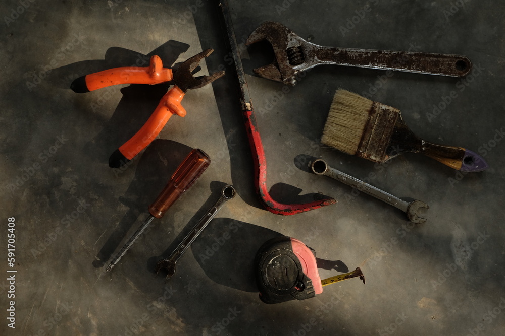 Set of assorted work tools. Various carpentry tools on wooden background.