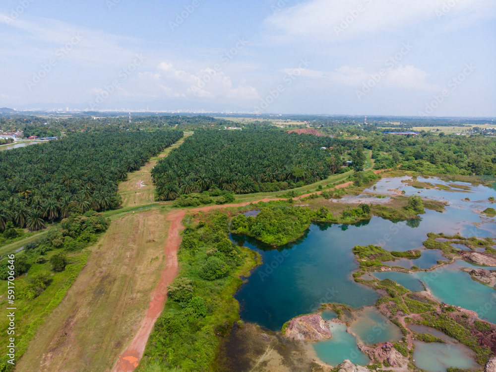 Aerial view of a small laterite mountain with a lots of small lake that reflect the sky colour.
