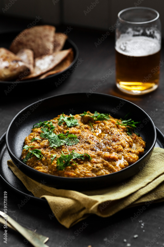 Side View of Indian Tarka Dal Curry with Roti, Beer and Cilantro Side View of Indian Tarka Dal Curry with Roti, Beer and Cilantro
