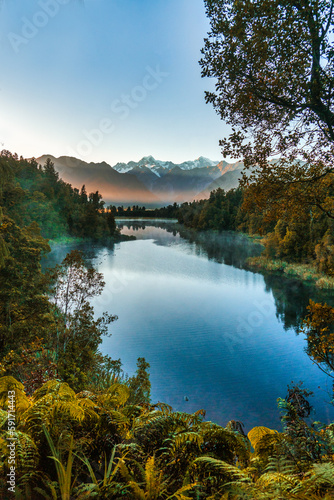 Fototapeta Naklejka Na Ścianę i Meble -  The natural untouched beauty of Lake Matheson captured at sunrise on a still calm early morning