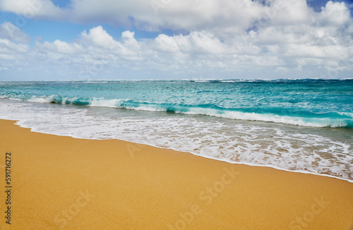 Ocean waves breaking onto a sand beach