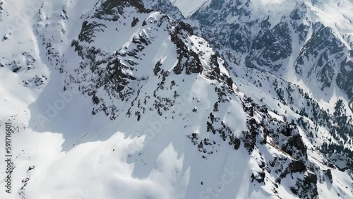 Wallpaper Mural Aerial of the snow covered mountains near Shymbulak in Kazakhstan. Drone slow pan shot to reveal mountain peaks Torontodigital.ca
