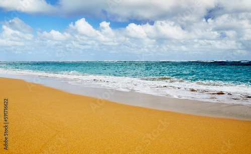 Ocean waves breaking onto a sand beach