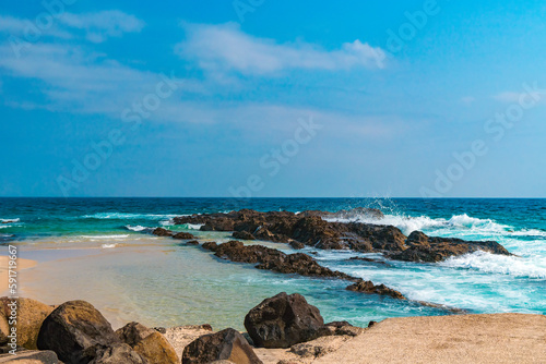 Stunning view of a turquoise ocean waves crushing on the shore of Snapper Rocks on the Gold Coast, Australia.