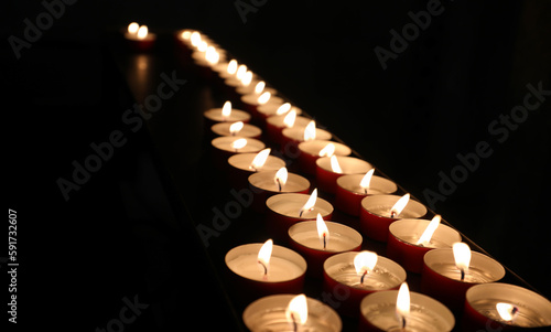 candles with flame lit during the mass of the faithful