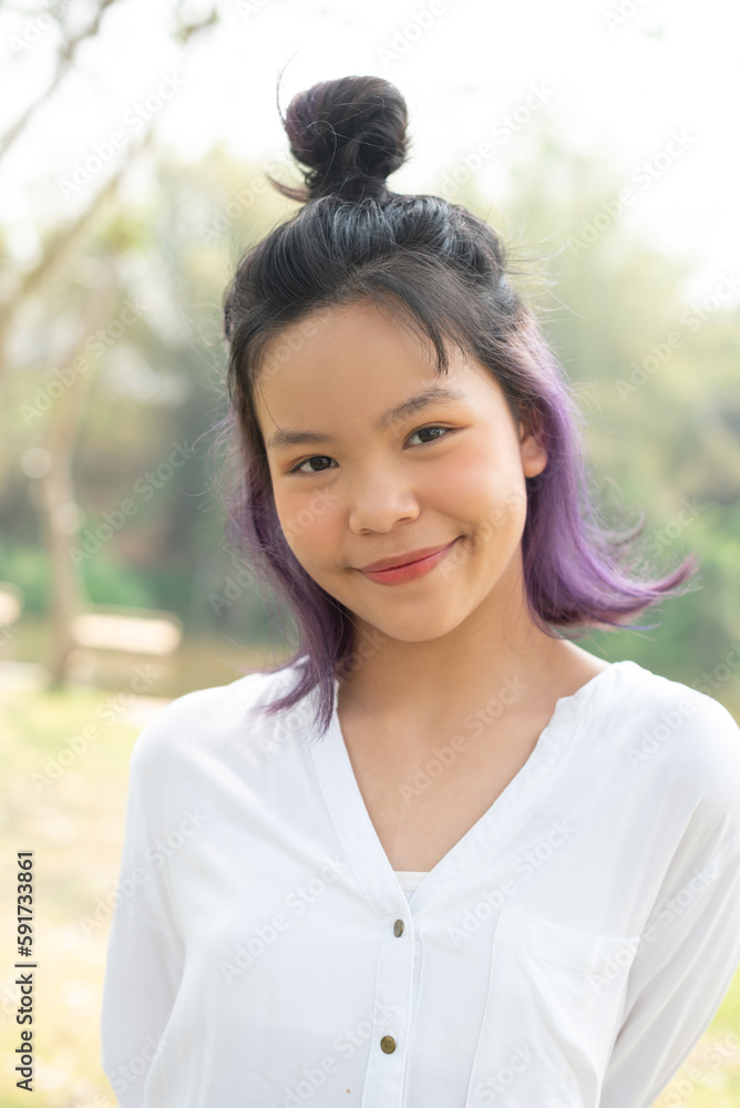 Happy teen girl 11-15 year old. Portrait of beautiful woman smiling with perfect smile and white teeth and looking away at park during sunset. Smile face asian lady girl wear casual cloth. Happy teen girl 11-15 year old. Portrait of beautiful woman smiling with perfect smile and white teeth and looking away at park during sunset. Smile face asian lady girl wear casual cloth.