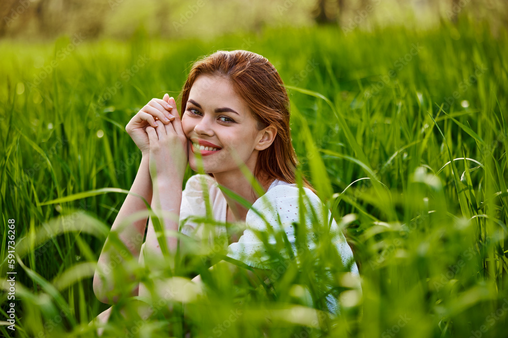 beautiful woman enjoying nature sitting in tall grass beautiful woman enjoying nature sitting in tall grass