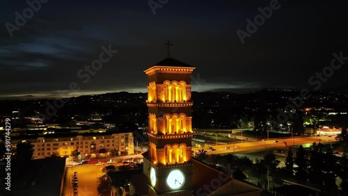 Cinematic night view of St. Andrews Church in Pasadena, aerial pullback over city photo