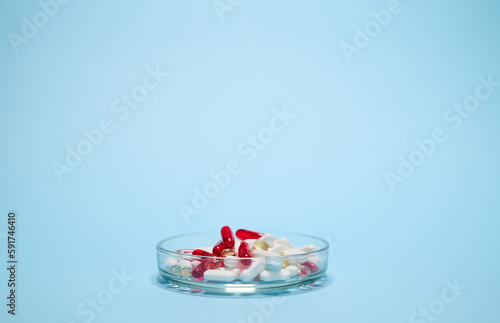 Petri dish with pharmaceutical pills and translucent gel capsules for medical treatment. World Health Day. Pharmacy business. Pharmaceutical industry. Healthcare and medicine. Copy advertising space