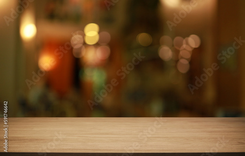 Empty wooden table in front of abstract blurred background of coffee shop . can be used for display or montage your products.Mock up for display of product © Charlie's