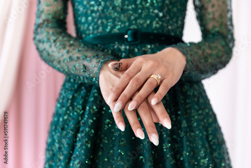 Afghani bride's hands traditional green dress close up