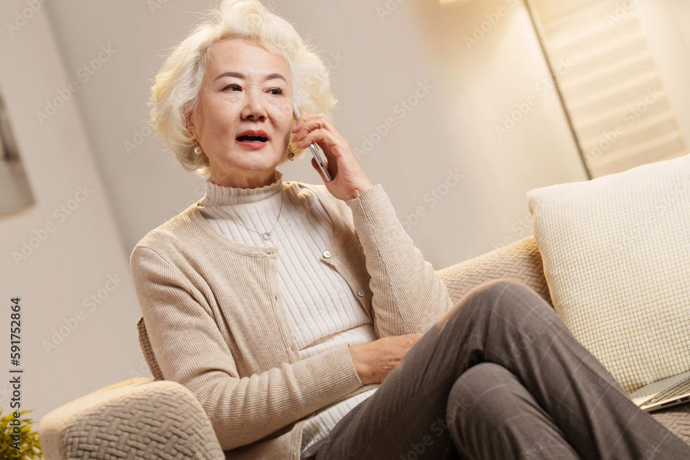 Elderly people sitting on couch talking on the phone Elderly people sitting on couch talking on the phone
