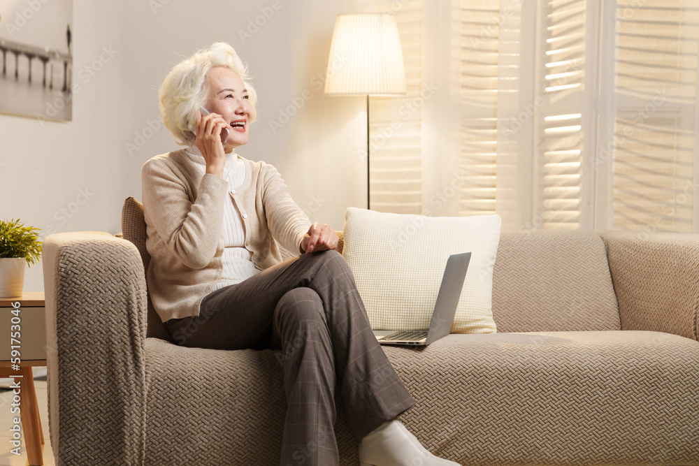 Elderly people sitting on couch talking on the phone Elderly people sitting on couch talking on the phone
