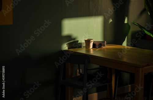 Table and chairs in a bar restaurant with sunlight and shadow. Almeria, Spain