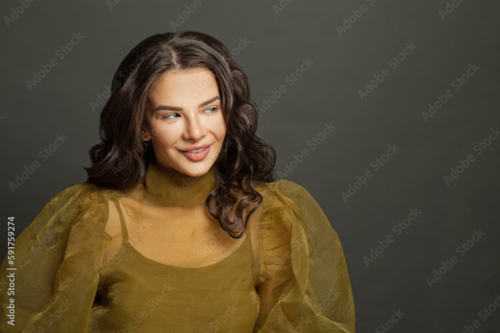 Cheerful fashion model woman with makeup and dark hair against black studio wall background Cheerful fashion model woman with makeup and dark hair against black studio wall background