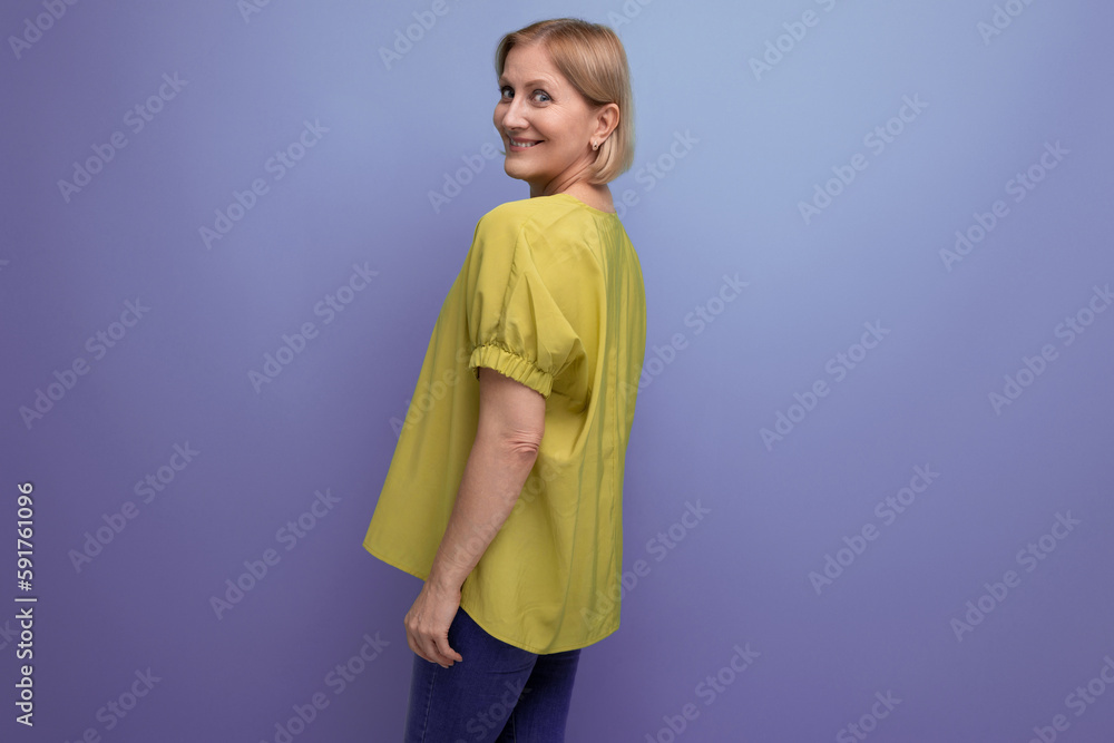 attractive blonde adult woman in yellow tank top posing attractive blonde adult woman in yellow tank top posing