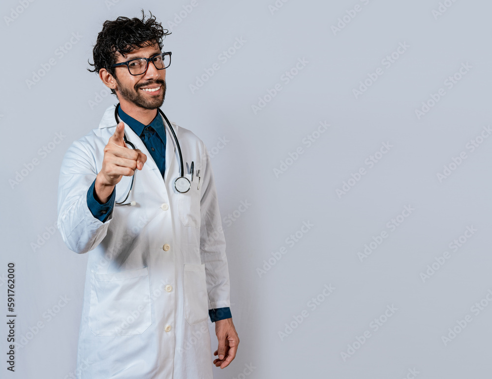 Smiling doctor pointing at you isolated. Young doctor pointing at you. Friendly doctor pointing at the camera