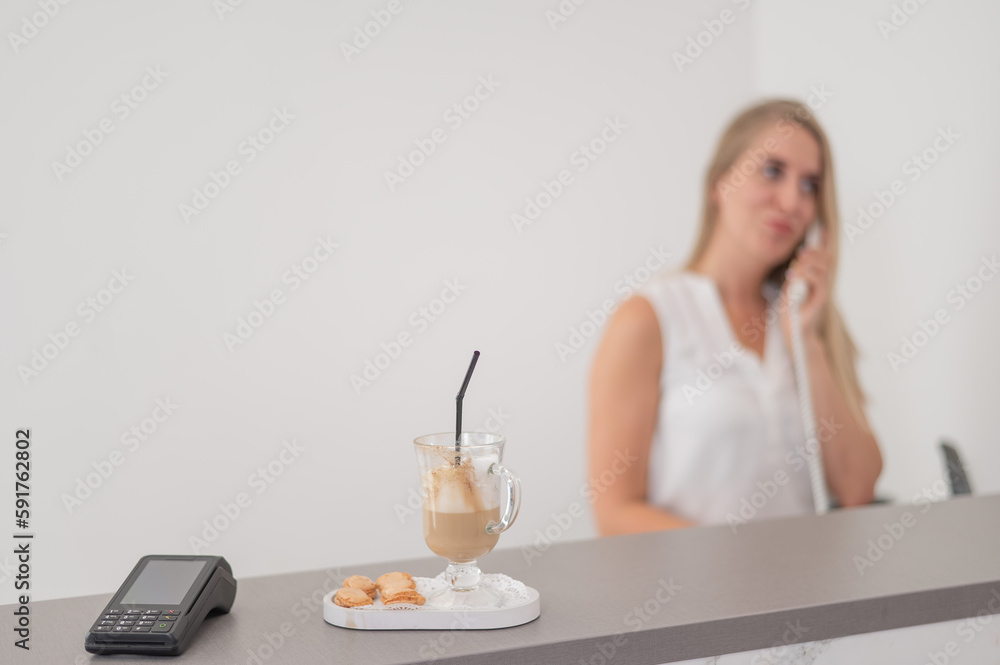 Receptionist in a beauty salon talking to a client on the phone. Receptionist in a beauty salon talking to a client on the phone.