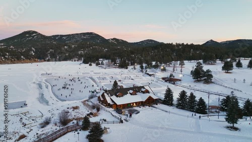 Wallpaper Mural Evergreen Lake house January mid winter ice skating, pond hockey and ice fishing under lights sunset Colorado circle left cinematic Torontodigital.ca