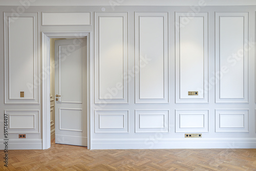 horizontal front shot of interior on white wall with closed slightly open door and wooden parquet