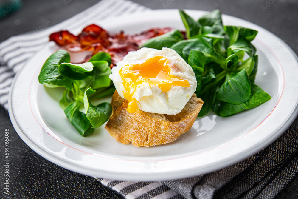poached egg breakfast bacon, green leaves salad mix meal food snack on the table copy space food background rustic top view poached egg breakfast bacon, green leaves salad mix meal food snack on the table copy space food background rustic top view