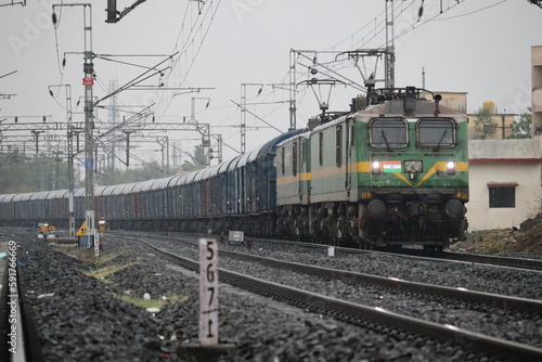the indian train moving on railway track with white sky