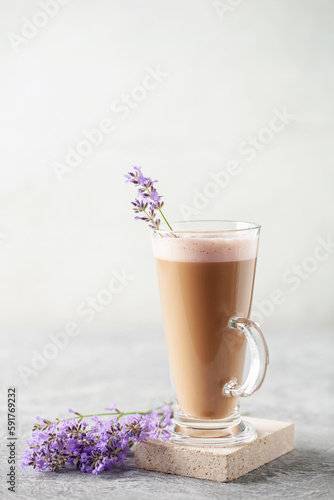 Coffee cup of cappuccino with lavender flowers . Cozy breakfast.