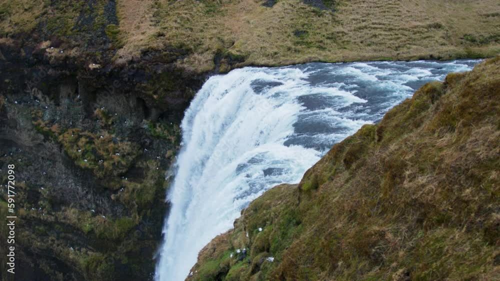 Top view of Skogafoss waterfall in Iceland, water flowing over edge