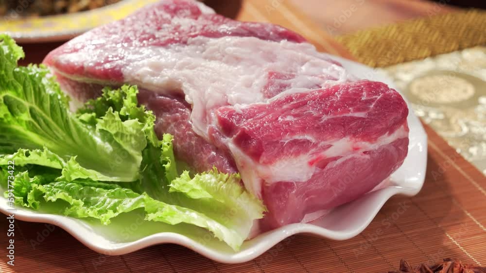 Fresh pork in a white porcelain dish Fresh pork in a white porcelain dish