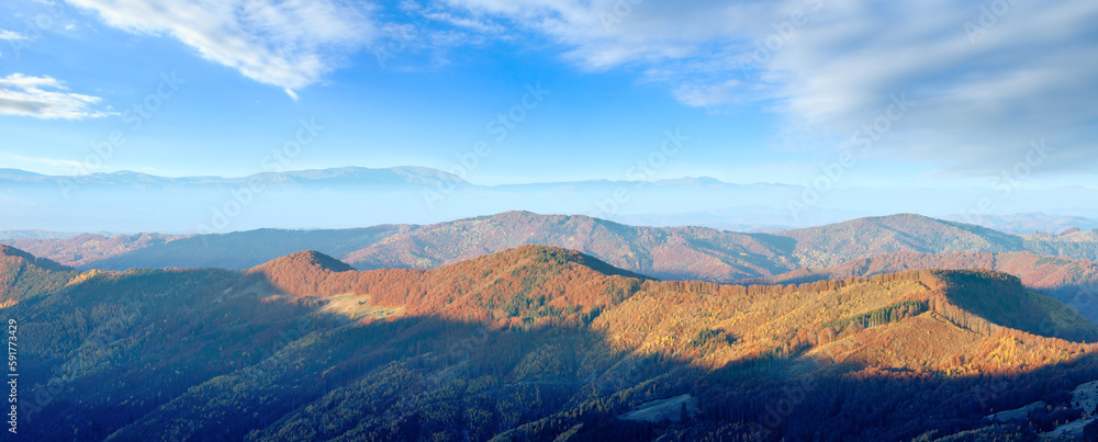 Colorful mountain slopes in autumn Carpathian. Morning misty panorama.