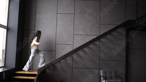 Young woman go up on the strait at home